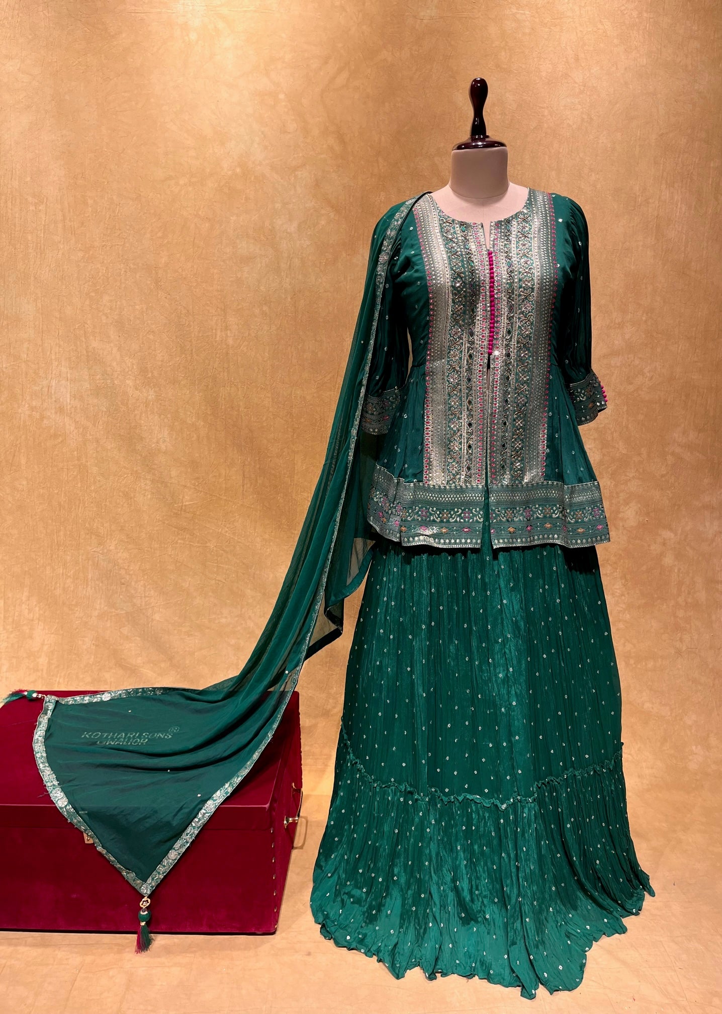 (DELIVERY IN 20-25 DAYS) BOTTLE GREEN COLOUR BANDHANI PRINT PEPLUM BLOUSE & SKIRT EMBELLISHED WITH CUTDANA &  MIRROR WORK
