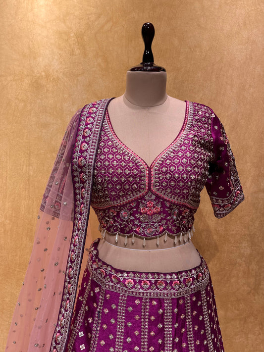 (DELIVERY IN 20-25 DAYS) PURPLE COLOUR HAND EMBROIDERED SILK LEHENGA EMBELLISHED WITH SEQUINS, PEARL, AARI WORK