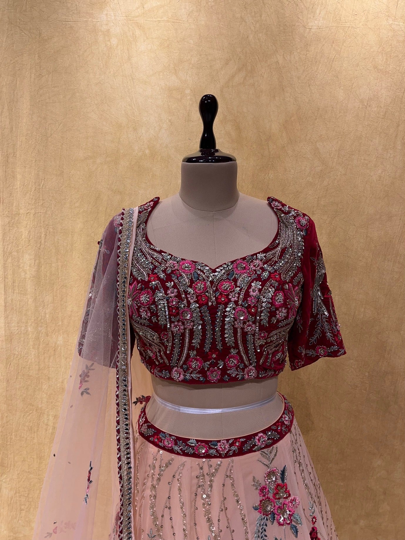 (DELIVERY IN 20 DAYS) BRIDESMAIDS READYMADE PEACH COLOUR GEORGETTE LEHENGA WITH MAROON VELVET CROP TOP BLOUSE EMBELLISHED WITH CUTDANA, SEQUINS & RESHAM WORK.