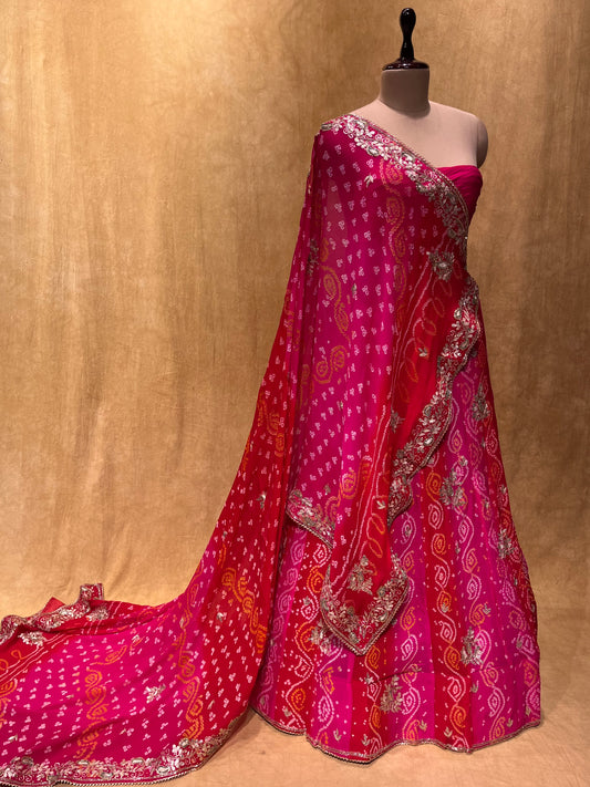 (DELIVERY IN 20-25 DAYS) PINK SHADED BANDHEJ LEHENGA WITH UNSTITCHED BLOUSE EMBELLISHED WITH GOTA PATTI & CUTDANA WORK