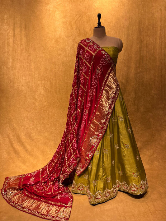 (DELIVERY IN 30 DAYS) OLIVE GREEN COLOUR SILK LEHENGA WITH CONTRAST RED GHARCHOLA DUPATTA